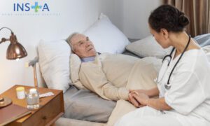 nurse assisting elderly man